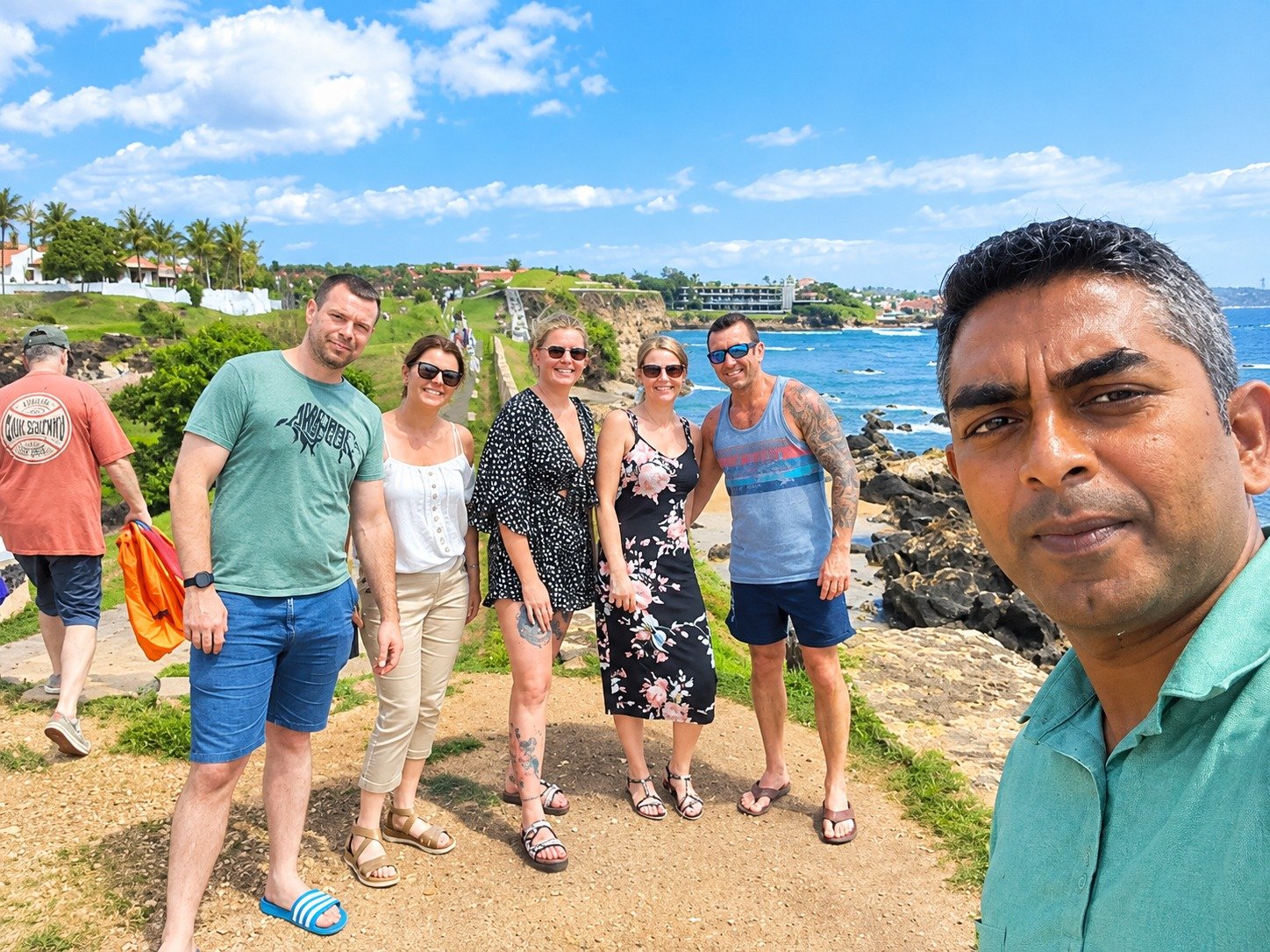 Travel group enjoying the sunny ocean ramparts at Galle Fort